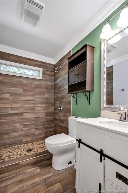 bathroom with crown molding, vanity, toilet, and hardwood / wood-style floors