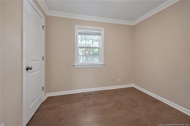 empty room featuring crown molding and dark hardwood / wood-style floors