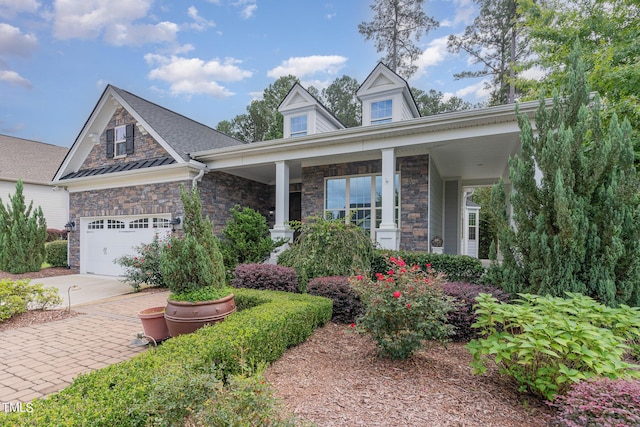 view of front of house featuring a porch and a garage