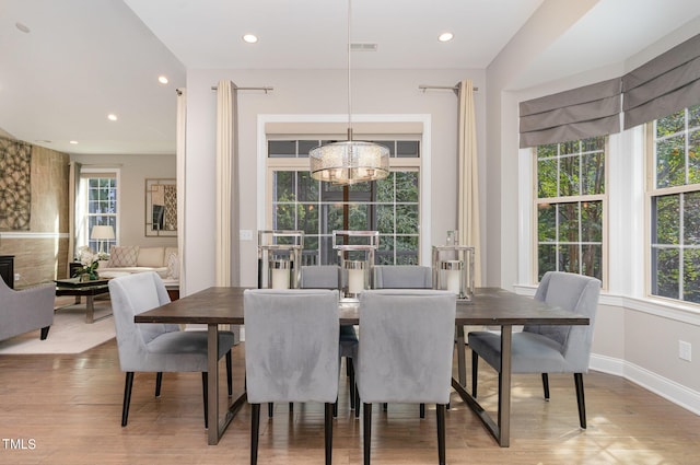 dining area featuring an inviting chandelier and light wood-type flooring