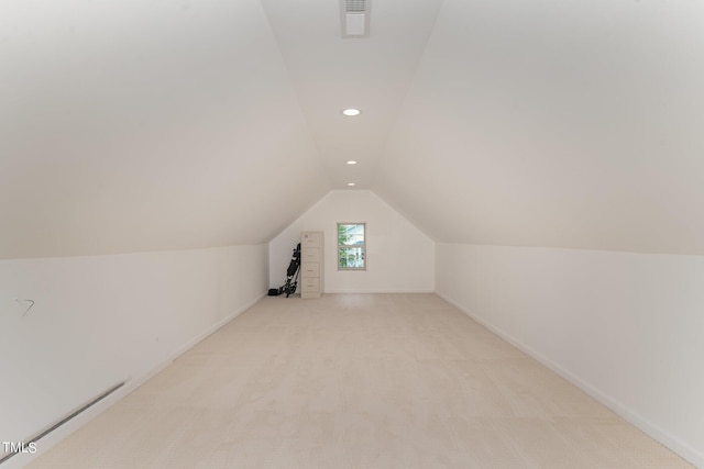 bonus room featuring light carpet and vaulted ceiling