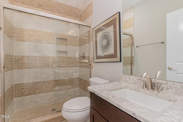 bathroom featuring walk in shower, vanity, and toilet