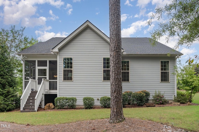 back of house with a sunroom and a yard