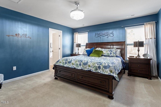 bedroom with light carpet, visible vents, and baseboards