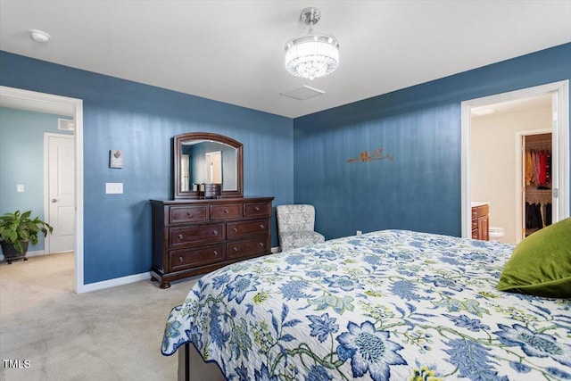 bedroom with light colored carpet, a notable chandelier, and baseboards