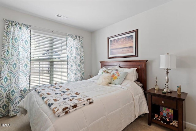 bedroom featuring carpet floors and visible vents