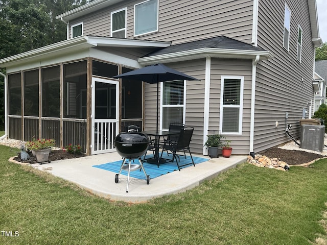 rear view of house with a sunroom, a patio area, cooling unit, and a lawn