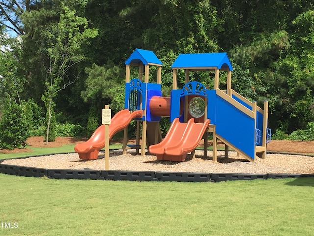 community jungle gym featuring a lawn