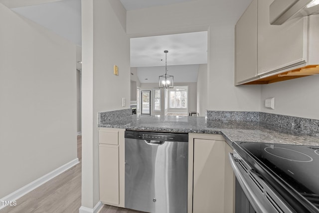 kitchen featuring light hardwood / wood-style flooring, stainless steel appliances, a chandelier, and stone counters