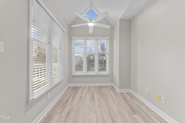 empty room with lofted ceiling, ceiling fan, and light wood-type flooring