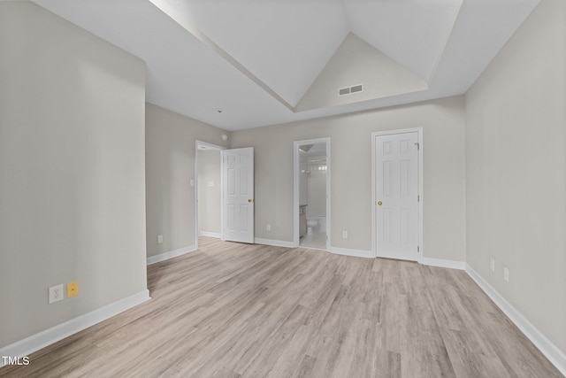 unfurnished room with light hardwood / wood-style flooring and vaulted ceiling