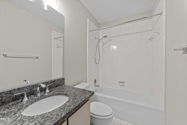 full bathroom with tiled shower / bath, vanity, and toilet