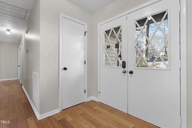 foyer with wood-type flooring