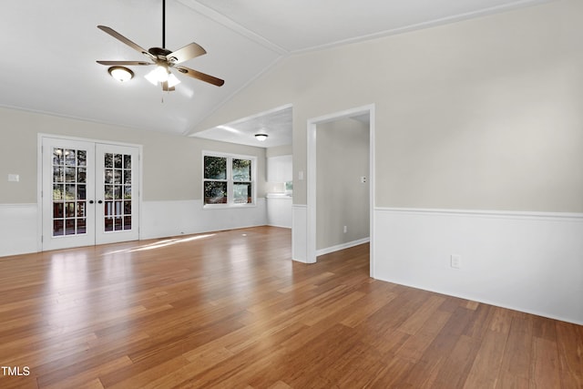 unfurnished living room with lofted ceiling, light hardwood / wood-style flooring, french doors, and ceiling fan