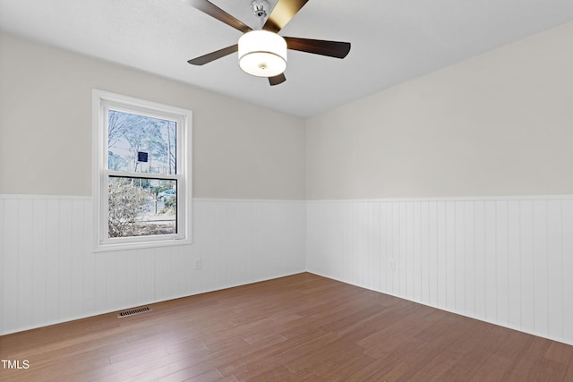 unfurnished room featuring ceiling fan and hardwood / wood-style floors