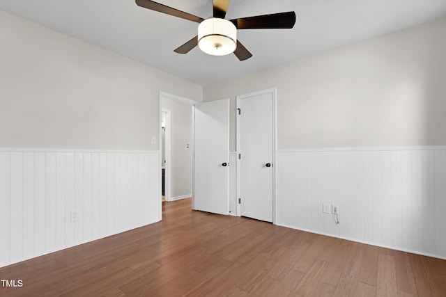 spare room featuring wood-type flooring and ceiling fan