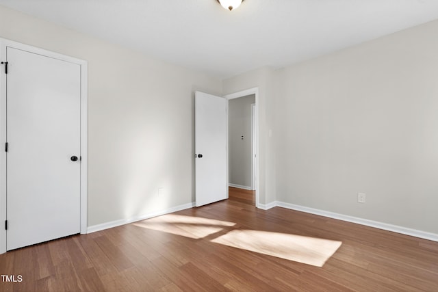 unfurnished bedroom featuring hardwood / wood-style flooring