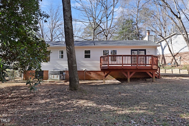 back of property with central AC and a deck