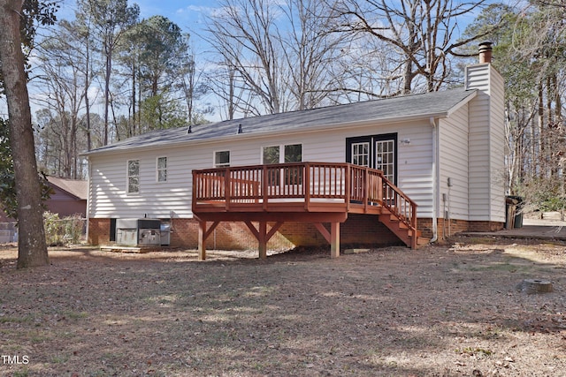 back of house featuring a wooden deck and central AC