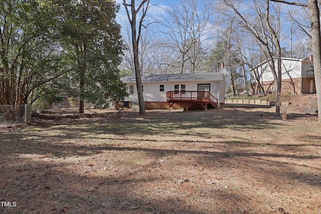 exterior space with a deck and a lawn