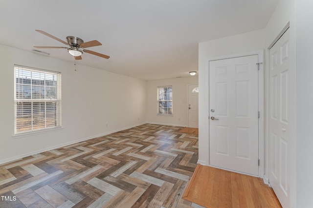 foyer entrance featuring ceiling fan and light parquet floors