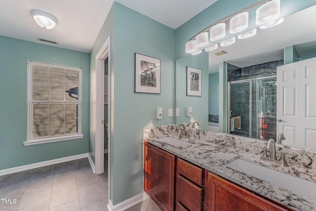 bathroom featuring vanity, tile patterned floors, and a shower with door