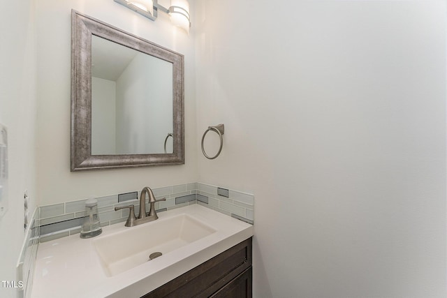 bathroom featuring vanity and decorative backsplash