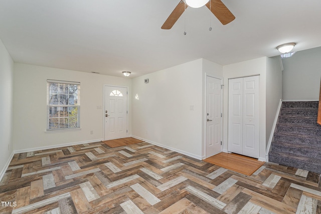 foyer entrance with parquet flooring and ceiling fan