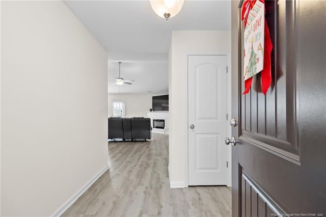 hallway with light hardwood / wood-style floors