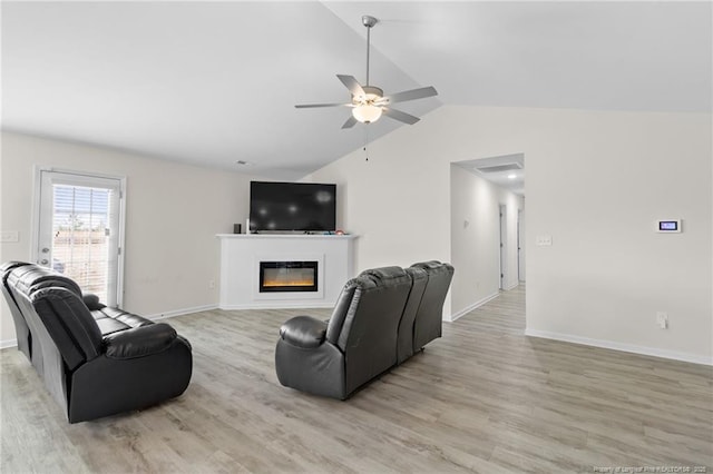 living room featuring lofted ceiling, hardwood / wood-style flooring, and ceiling fan