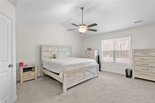 bedroom featuring vaulted ceiling, light carpet, and ceiling fan