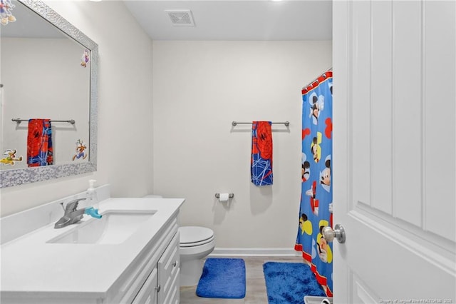 bathroom featuring vanity and toilet