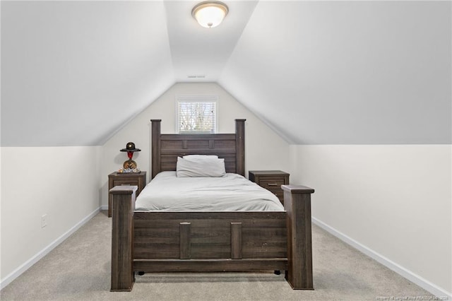 carpeted bedroom with lofted ceiling