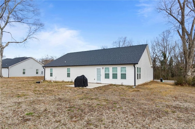 rear view of property with a patio area and a lawn