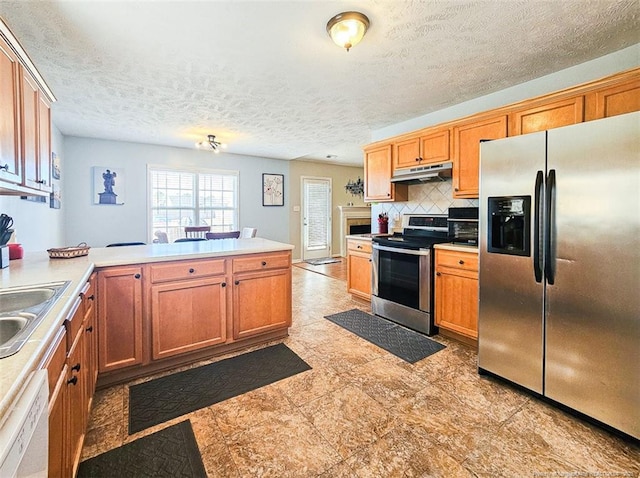 kitchen featuring appliances with stainless steel finishes, sink, backsplash, kitchen peninsula, and a textured ceiling