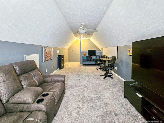 office featuring ceiling fan, vaulted ceiling, a textured ceiling, and carpet flooring