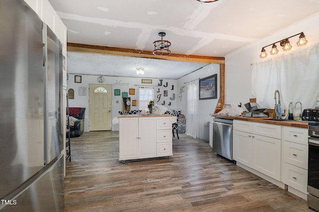 kitchen with white cabinetry, appliances with stainless steel finishes, sink, and dark wood-type flooring