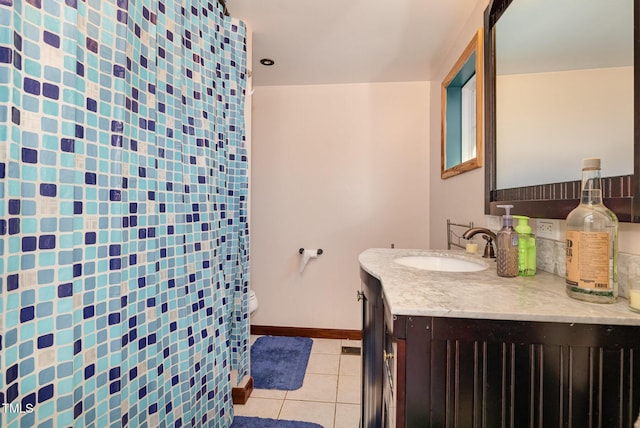 bathroom with vanity, tile patterned floors, and toilet