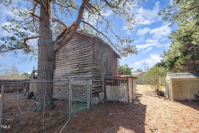 view of property exterior featuring a storage unit