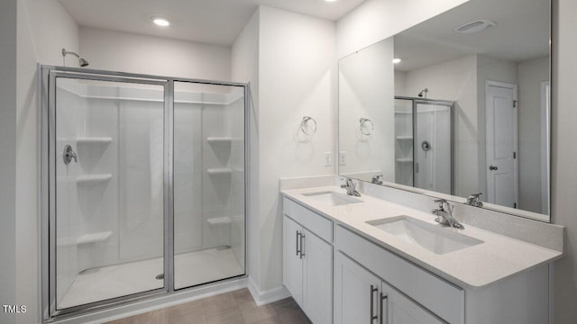 bathroom with vanity and a shower with door