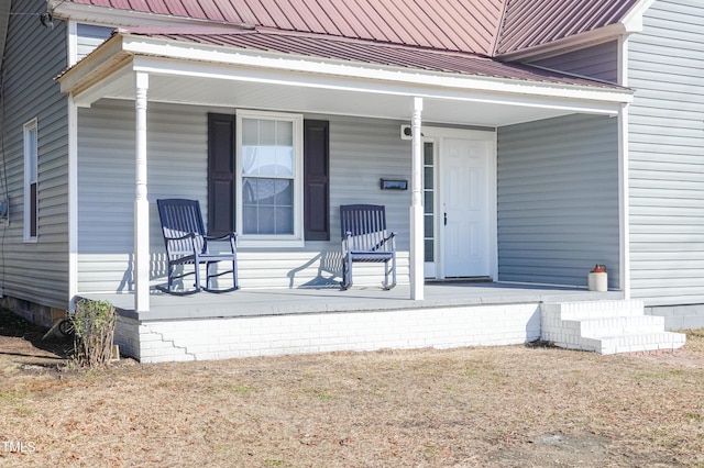 view of exterior entry featuring covered porch