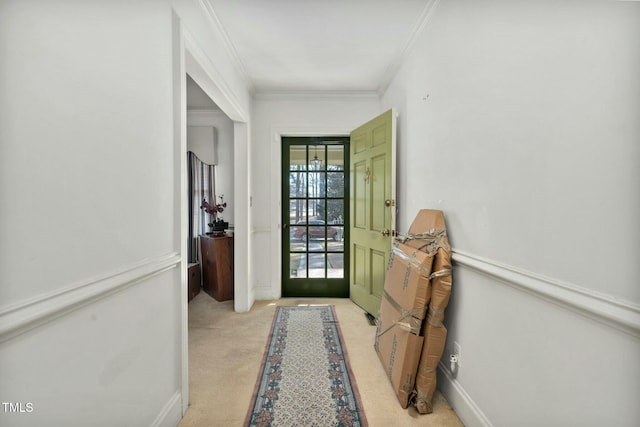 entryway with ornamental molding and light colored carpet