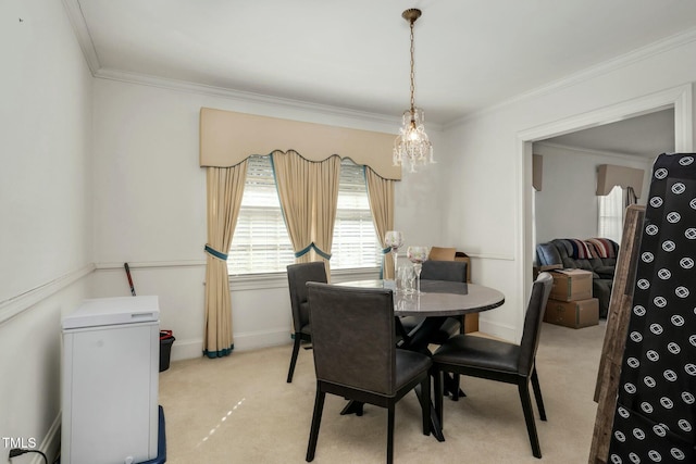 carpeted dining area with ornamental molding and a chandelier