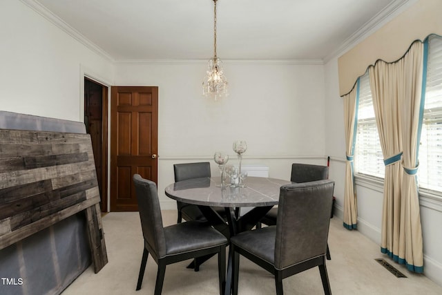 dining area featuring ornamental molding and light carpet