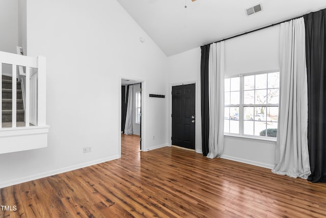 spare room featuring ceiling fan, high vaulted ceiling, and hardwood / wood-style floors