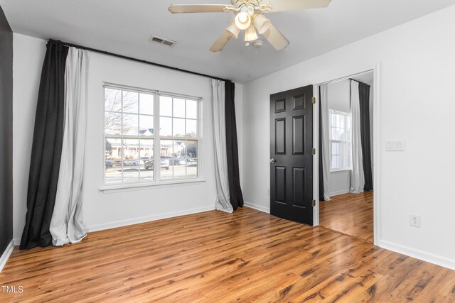 unfurnished room with light hardwood / wood-style flooring and ceiling fan