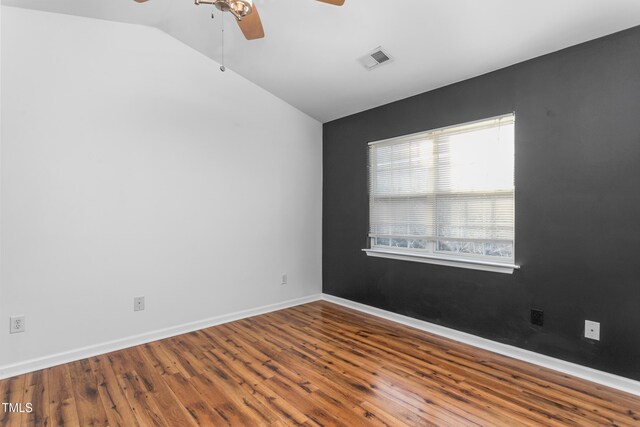 unfurnished room featuring lofted ceiling, hardwood / wood-style floors, and ceiling fan