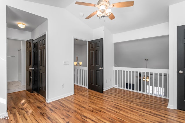 spare room featuring ceiling fan, vaulted ceiling, and hardwood / wood-style floors