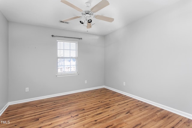 spare room featuring hardwood / wood-style floors and ceiling fan