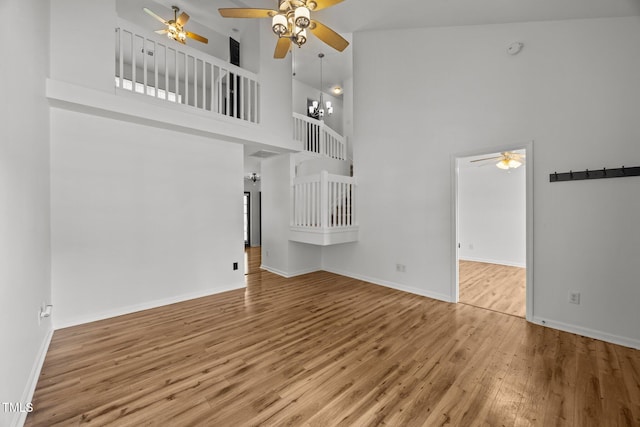4619 Cross Ridge Ln, Greensboro, NC 27410 - unfurnished living room featuring a ceiling fan, a towering ceiling, and wood finished floors